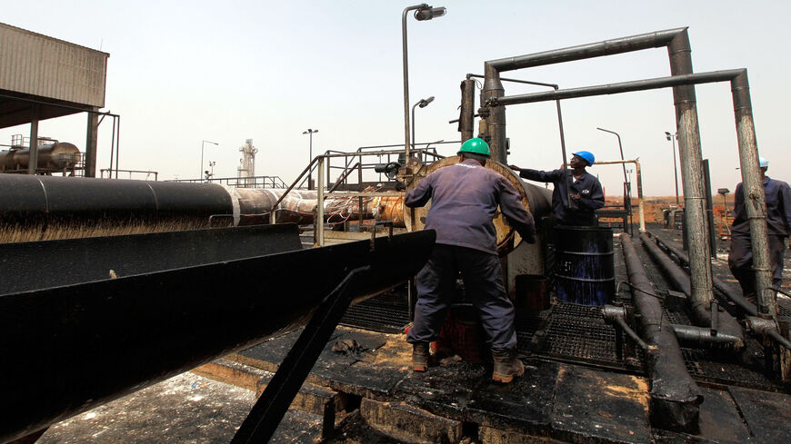 Sudanese repair crew work at the Heglig oil facility, after Sudan started pumping oil again from the war-damaged oil field on May 2, 2012, 12 days after occupying South Sudanese troops left the area.