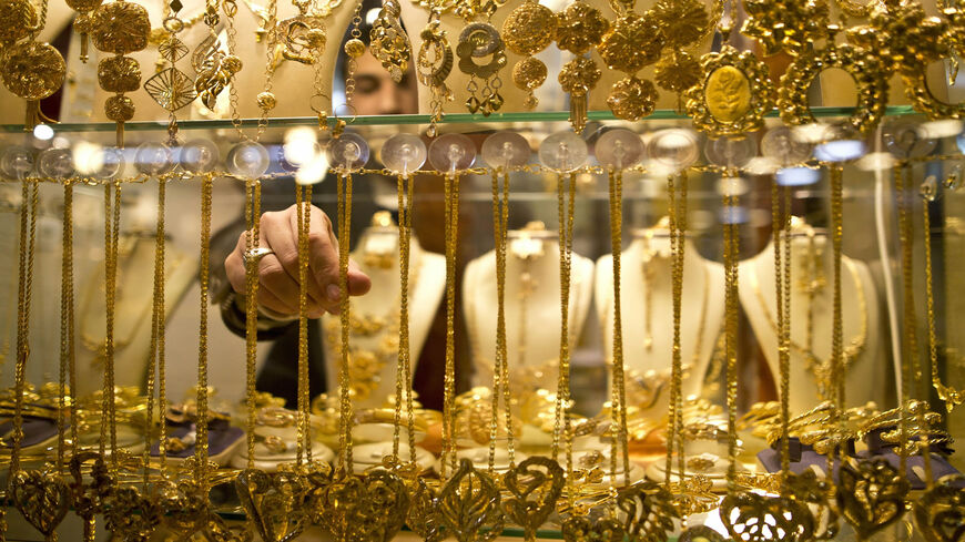 A Palestinian vendor displays a necklace in a window case at a gold market in Gaza City's historic old quarter, Gaza Strip, March 30, 2016.