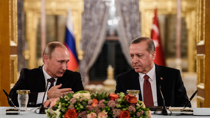 Russian President Vladimir Putin (L) speaks to Turkish President Recep Tayyip Erdogan (R) as they attend a press conference on Oct. 10, 2016, in Istanbul. Putin visited Turkey for talks pushing forward ambitious joint energy projects as the two sides try to overcome a crisis in ties. 
