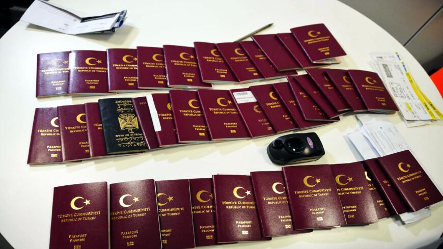 Fake passports and travel documents are displayed on a table for the press on Dec. 19, 2019, at the Istanbul airport in Turkey. 