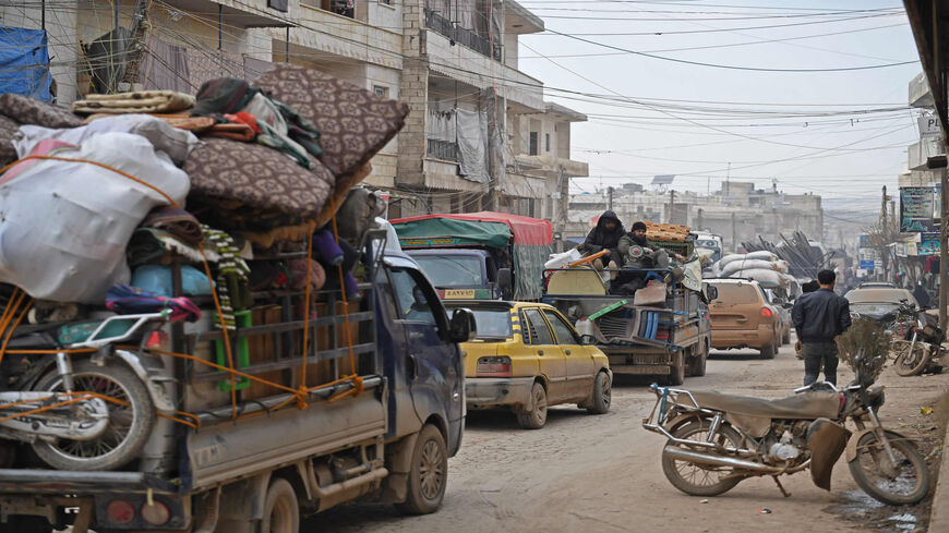 Vehicles carrying internally displaced persons and their belongings drive through the town of Atme near the Turkish border toward the city of Afrin, as people flee advancing Syrian regime forces in Idlib and Aleppo provinces, Syria, Feb. 17, 2020.