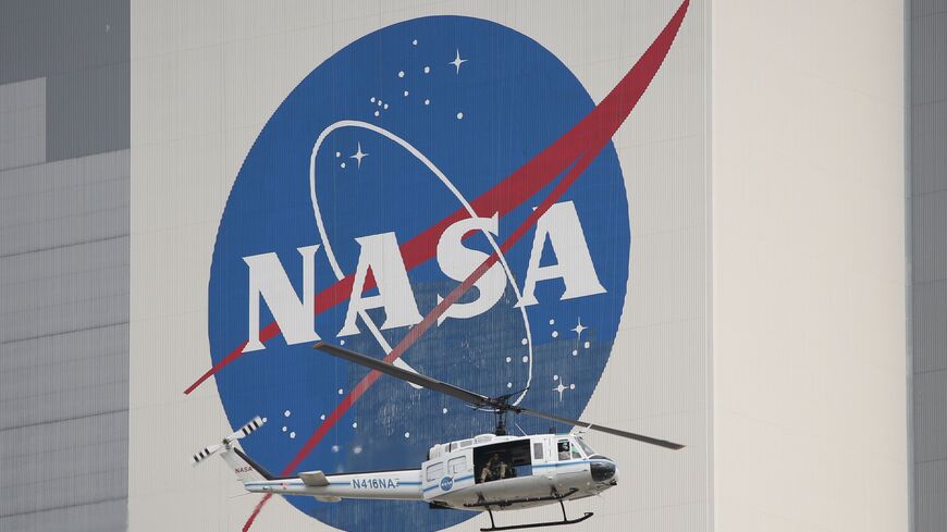 A NASA security helicopter flies past the Vehicle Assembly Building on launch day at the Kennedy Space Center, Florida, United States, May 26, 2020.