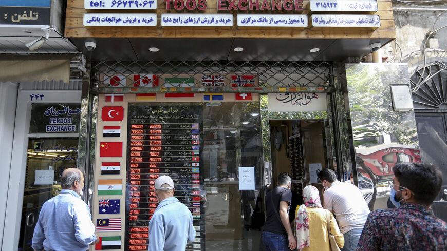 Iranians check a display board at a currency exchange shop in the capital Tehran, on Sept. 29, 2020. For Iran, struggling from sanctions imposed under Washington's policy of "maximum pressure", the US presidential race raised hope of change — but also fears that life could get even worse.