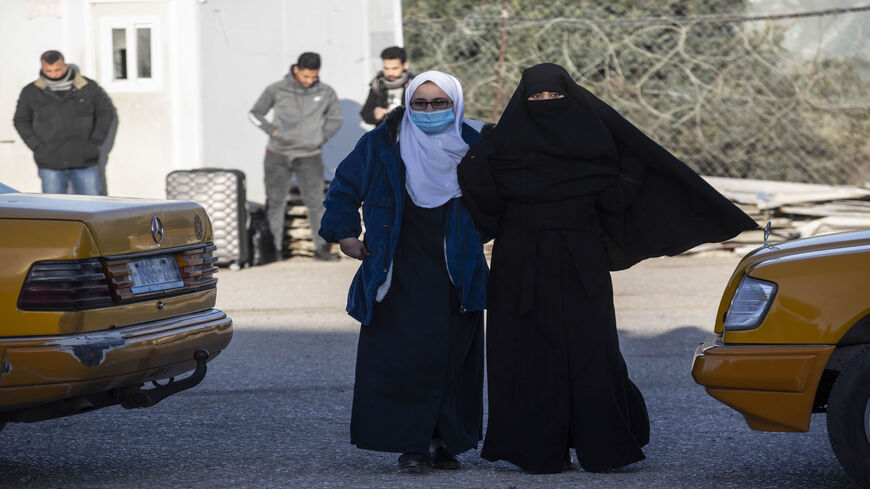 Palestinian women wait to leave the Rafah border crossing after it was opened by Egyptian authorities, in the southern Gaza Strip, Feb. 17, 2021.