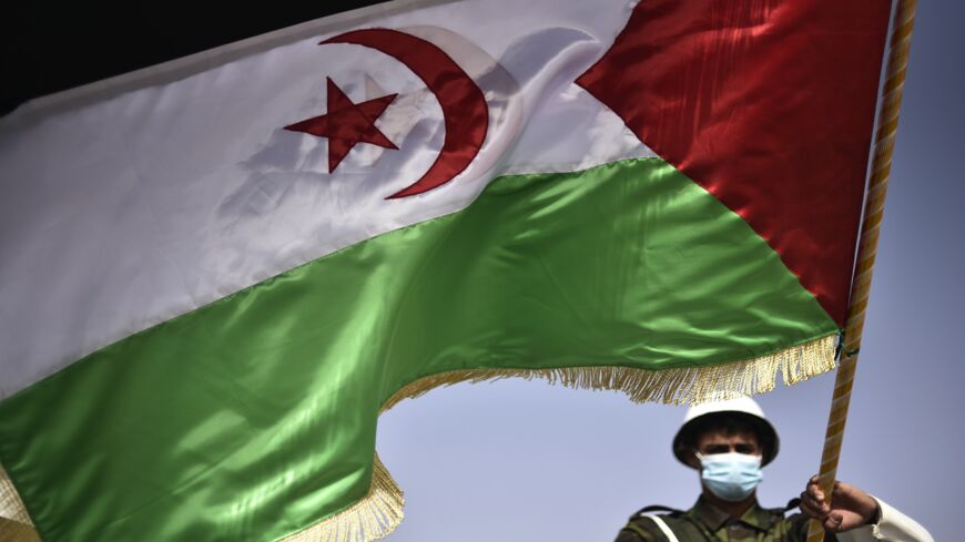 A Sahrawi soldier waves the Sahrawi flag during a parade marking the 45th anniversary of the declaration of the Sahrawi Arab Democratic Republic (SADR), at a refugee camp on the outskirts of the southwestern Algerian city of Tindouf, on Feb. 27, 2021. 
