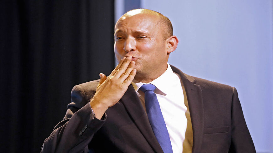 Naftali Bennett, leader of the Israeli right-wing Yamina party, blows kisses as he greets supporters at his party's campaign headquarters after the end of voting in the fourth national election in two years, Tel Aviv, Israel, March 24, 2021.