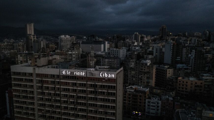 An aerial view shows Lebanon's capital, Beirut, in darkness during a power outage on April 3, 2021. As Lebanon battles its worst financial crisis in decades, the local currency has lost more than 85% of its value on the black market. Even the country's once richest city council says it is struggling to maintain its streets, as the economic squeeze puts pressure on already rundown infrastructure.