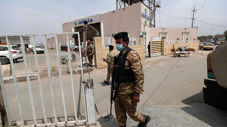 Members of Iraqi security forces close access to the Ibn Al-Khatib Hospital in Baghdad, on April 25, 2021, after a fire erupted in the medical facility reserved for the most severe COVID-19 cases.