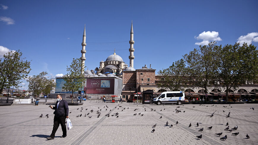 A man walks across the deserted Eminonu Square in Istanbul on May 9, 2021, during a new lockdown aimed at fighting a surging third wave of COVID-19 infections. 