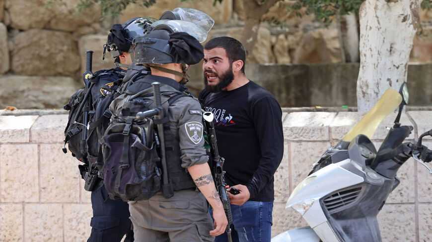 A Palestinian protester argues with Israeli security forces in the Old City of Jerusalem, as a planned march marking Israel's 1967 takeover of the holy city threatened to further inflame tensions, May 10, 2021.