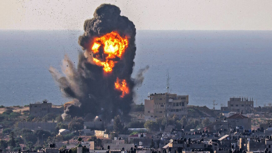 Smoke billows from an explosion following an Israeli air strike in Rafah in the southern Gaza Strip on May 13, 2021. 
