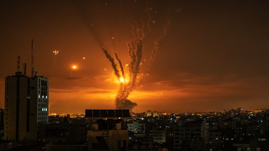 Rockets launched toward Israel from the northern Gaza Strip and response from the Israeli missile defense system known as the Iron Dome leave streaks through the sky on May 14, 2021, in Gaza City, Gaza.
