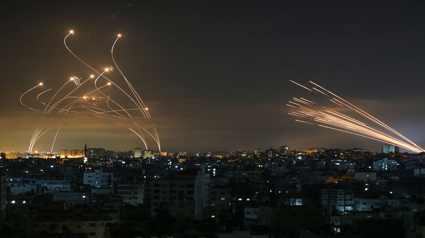Rockets are seen in the night sky fired toward Israel from Beit Lahia, northern Gaza Strip, May 14, 2021.