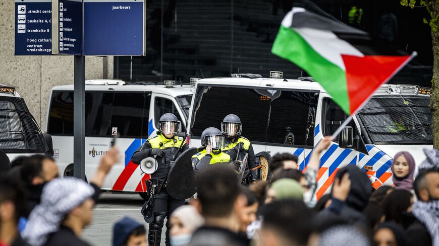 Riot police officers stand in front of demonstrators during a protest in support of Palestine on Jaarbeursplein in Utrecht, on May 14, 2021. 