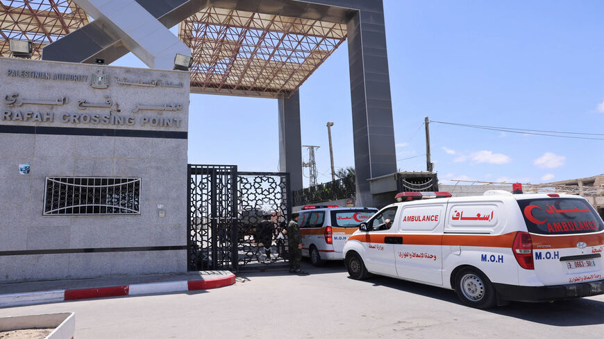 Ambulances evacuating injured Palestinians to Egypt for treatment arrive at the Rafah border crossing with the neighboring country, in the southern Gaza Strip, May 17, 2021.