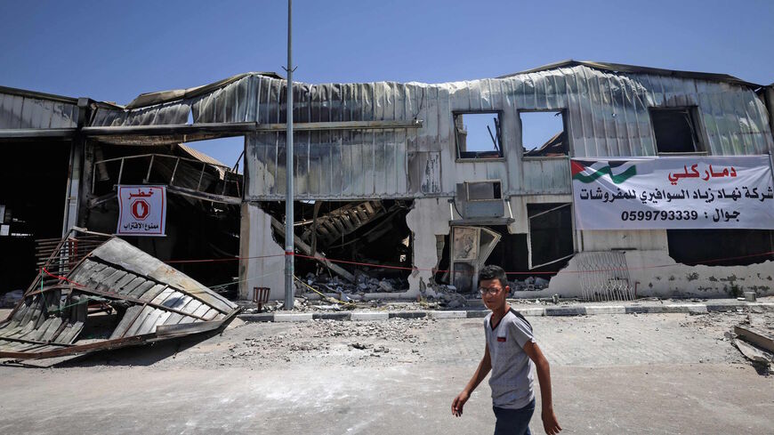 A Palestinian worker inspects the damage at a factory in Gaza's industrial area, on May 25, 2021, which was hit by Israeli strikes prior to a cease-fire ending 11 days of deadly violence between Israel and the Palestinian Hamas movement which runs the enclave.  