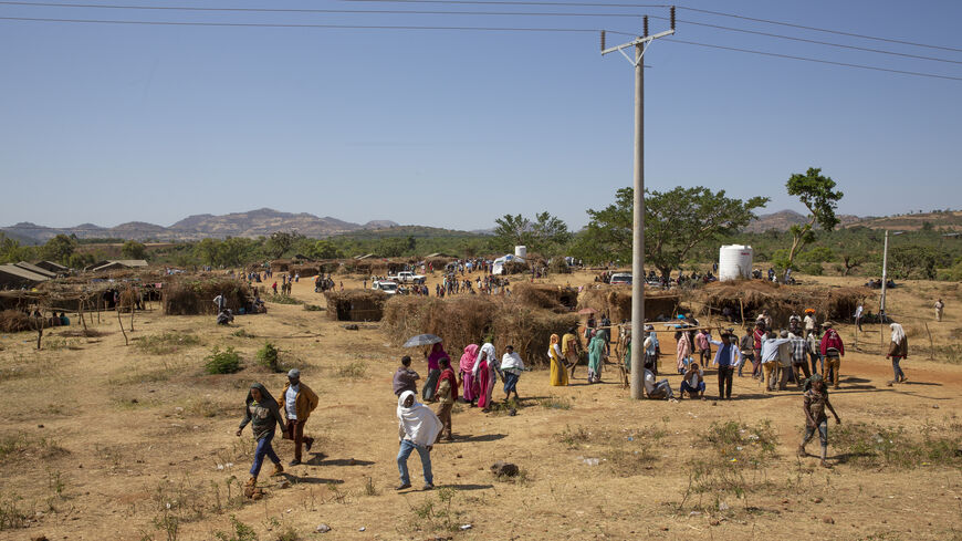 Survivors and refugees of the Benishangul-Gumuz massacre walk through the displaced persons camp in the city of Chagni, Ethiopia, Dec. 31, 2020.