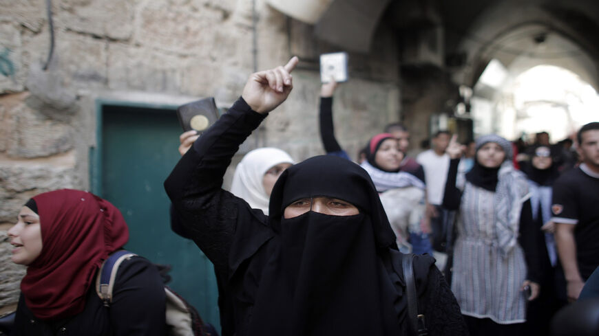 Palestinian women from the murabitat shout slogans during a protest against Jewish groups visiting Al-Aqsa Mosque compound, Jerusalem, Sept. 20, 2015.