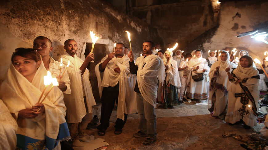 Ethiopian Christian pilgrims hold candles during an Ethiopian Orthodox ceremony of the "Holy Fire" at Deir Al-Sultan Church held on the roof of the Holy Sepulcher in the Old City of Jerusalem, April 30, 2016.