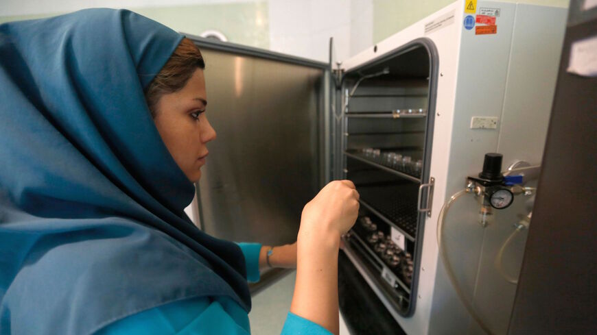 An Iranian medical staff works with samples at the Avicenna embryology and infertility centre in Tehran on June 29, 2016. 