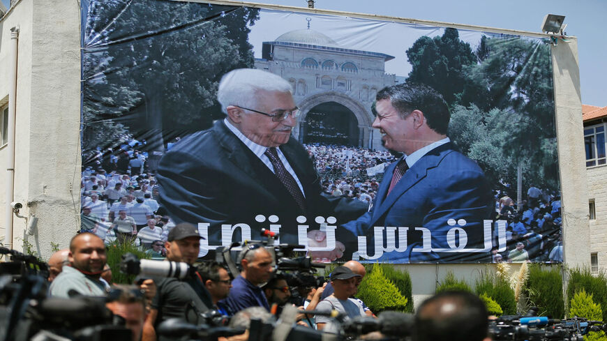 A photo montage of Jordan's King Abdullah (R) and Palestinian President Mahmoud Abbas shaking hands in front of Al-Aqsa Mosque compound is seen on a building during a welcome ceremony of the Jordanian king in Ramallah, West Bank, Aug. 7, 2017.