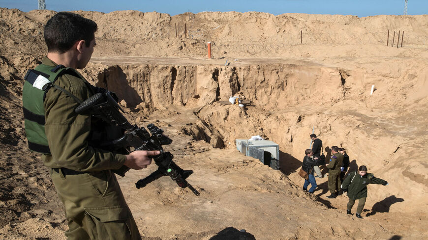 A picture taken from the Israeli side of the border with the Gaza Strip shows Israeli soldiers standing near the entrance of a tunnel that Israel says was dug by Islamic Jihad, leading from the Palestinian enclave into Israel, near the kibbutz of Kissufim, Israel, Jan. 18, 2018.