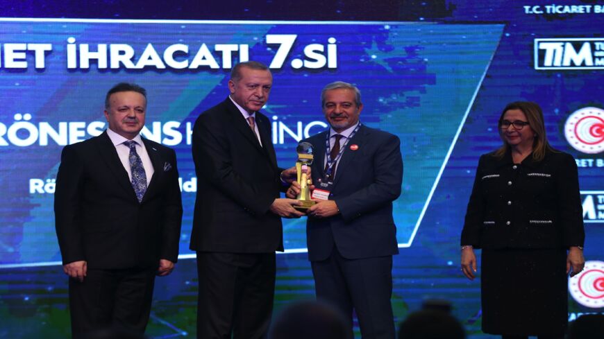 Turkish President Recep Tayyip Erdogan (2nd L) gives an award to Ronesans Holding Member of Board Ferit Seyfi Yagmuroglu (2nd R) during Turkey's 500 Largest Service Exporters Award Ceremony in Istanbul, Turkey, on Dec. 21, 2018. 