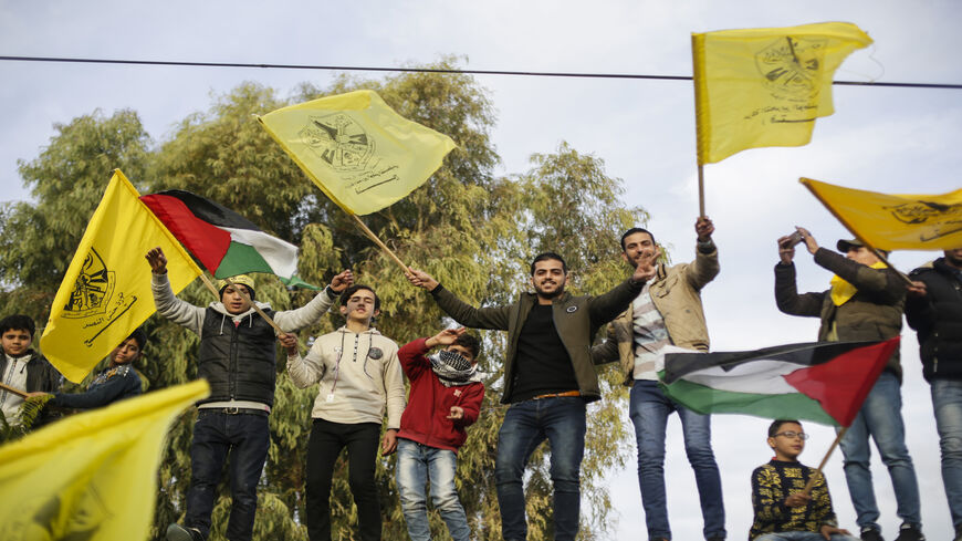 Palestinians wave yellow Fatah flags during a rally marking the 55th anniversary of the Fatah movement founding, Gaza City, Gaza Strip, Jan. 1, 2020.