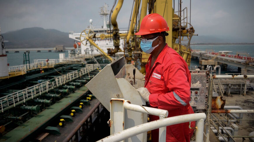 A worker of the Venezuelan state oil company PDVSA looks at the Iranian-flagged oil tanker Fortune as it docks at the El Palito refinery in Puerto Cabello in the northern state of Carabobo, Venezuela, on May 25, 2020. 