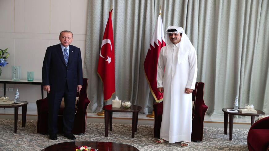 A handout picture taken and released on July 2 , 2020, by the Turkish Presidential Press service shows Turkey's President Recep Tayyip Erdogan (L) meeting Qatari Emir Sheikh Tamim bin Hamad Al Thani in Doha, Qatar.