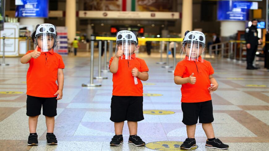 Travelers arrive at Kuwait International Airport, in Farwaniya, about 15 kilometers south of Kuwait City, on Aug. 1, 2020. Commercial flights resumed at Kuwait International Airport today after months of shut down due to the COVID-19 pandemic.