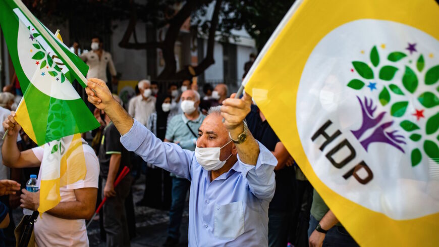 A man holds HDP flags as members of the pro-Kurdish Peoples Democratic Party (HDP) take part in a protest against the detention of HDP members, in Istanbul, on Sept. 25, 2020. 