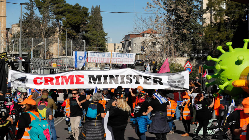 Israelis demonstrate outside the court as Prime Minister Benjamin Netanyahu's corruption trial resumes in occupied East Jerusalem, Feb. 8, 2021.