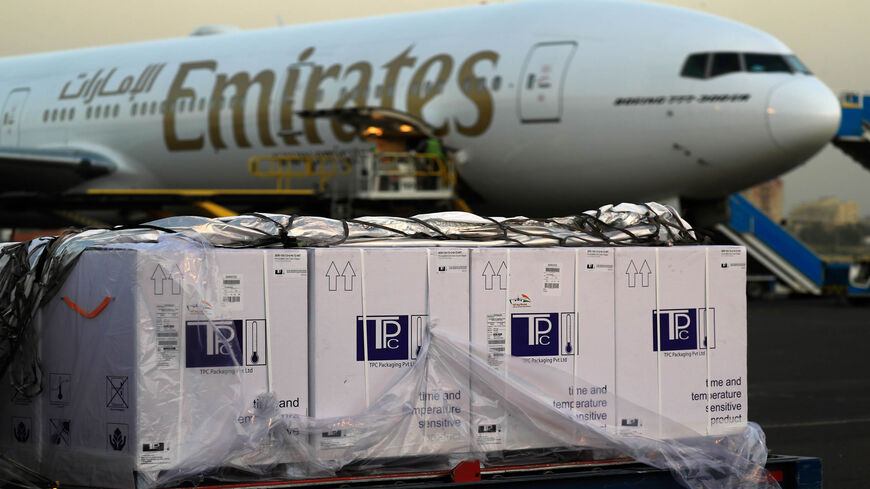 Boxes of coronavirus vaccines are stacked on the tarmac after the first batch arrived at Khartoum airport on an Emirates flight, Sudan, March 3, 2121.