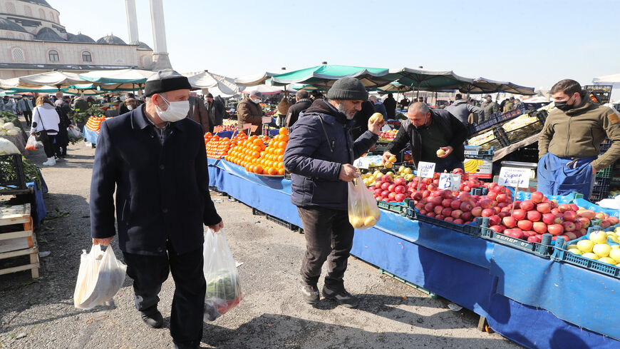 People wearing protective masks shop at a local market, amid the coronavirus pandemic,  Ankara, Turkey, Feb. 22, 2021.
