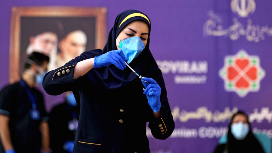 An Iranian health worker prepares an injection of the locally-made COVID-19 vaccine during the start of the second phase of trials in the capital Tehran on March 15, 2021. 