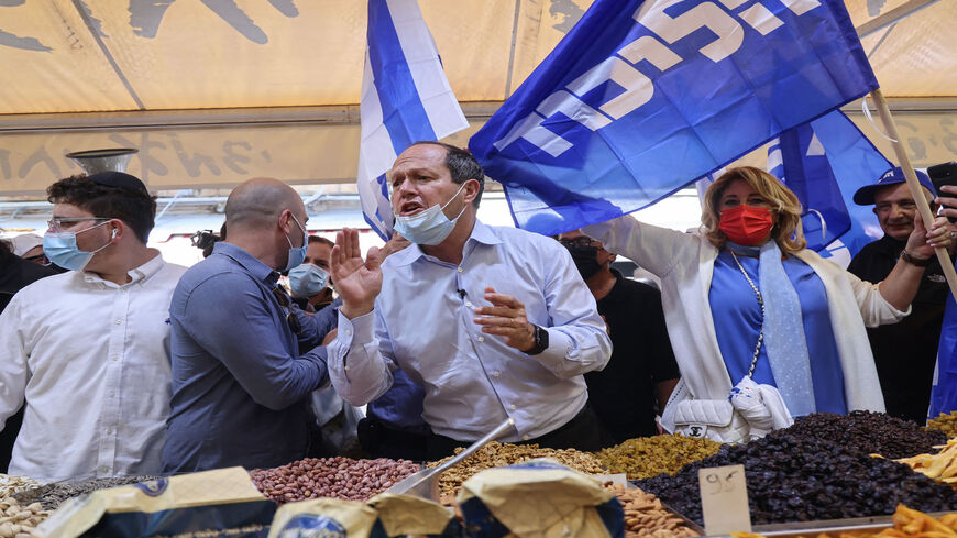 Israeli parliament member and former Jerusalem Mayor Nir Barkat meets voters during the election campaign for the Likud party, at Mahane Yehuda market, Jerusalem, March 19, 2021.