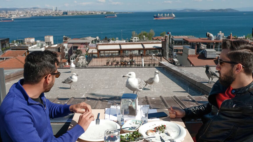 Tourists have a meal at a restaurant at Sultanahmet in Istanbul at Sultanahmet in Istanbul on May 9, 2021, during a new lockdown aimed at fighting a surging third wave of COVID-19 infections. 