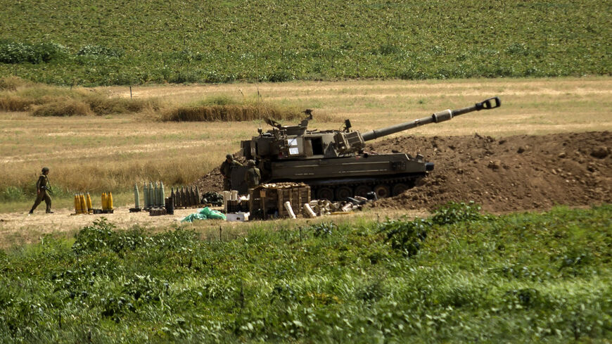An artillery unit soldier walks near an artillery unit near the border with the Gaza Strip, in Sderot, Israel, May 20, 2021. 
