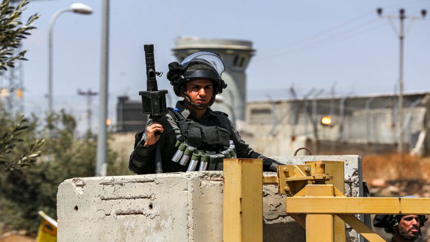 An Israeli border guard stands by a closed checkpoint entrance leading to the Palestinian village of Nilin west of Ramallah in the occupied West Bank, on May 29, 2021.