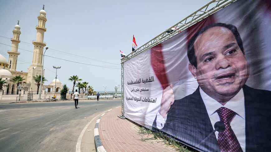 This picture taken on May 31, 2021 shows a view of a banner depicting Egypt's President Abdel Fattah al-Sisi with a quote from him reading in Arabic "the Palestinian issue will remain at the top of the priorities of the Egyptian state", amidst preparations to receive a visiting Egyptian intelligence delegation in Gaza City. 