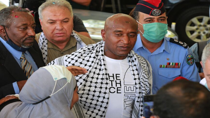 Palestinian-Jordanian Abdullah Abu Jaber, who was jailed in Israel after planting a bomb on a bus that wounded 13 civilians in 2000, is welcomed by his family upon his release at the Sheikh Hussein Crossing between Jordan and Israel on June 8, 2021.