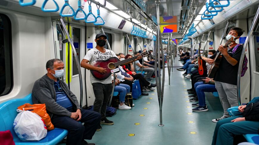 Amateur musicians play in the Istanbul metro during a performance ban due to the Covid-19 sanitary restrictions in Istanbul on June 9, 2021. 