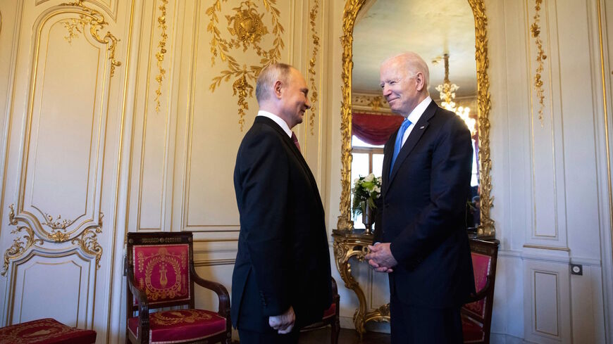 US President Joe Biden (R) talks to Russian President Vladimir Putin prior to the US-Russia summit at the Villa La Grange, in Geneva on June 16, 2021.