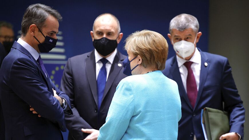 Angela Merkel (2ndR), talks to Greece's Prime Minister Kyriakos Mitsotakis 