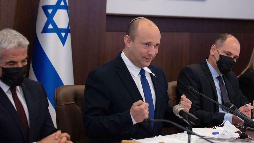 Israeli Prime Minister Naftali Bennett speaks as he chairs the weekly cabinet meeting in Jerusalem, on June 27, 2021. - The Israeli health ministry reimposed a requirement on June 25 for masks to be worn in enclosed public places, following a surge in Covid-19 cases since the rule was dropped 10 days earlier. 