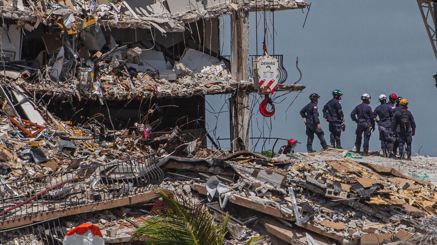 Search and Rescue teams look for possible survivors in the partially collapsed 12-story Champlain Towers South condo building on June 27, 2021 in Surfside, Florida. 