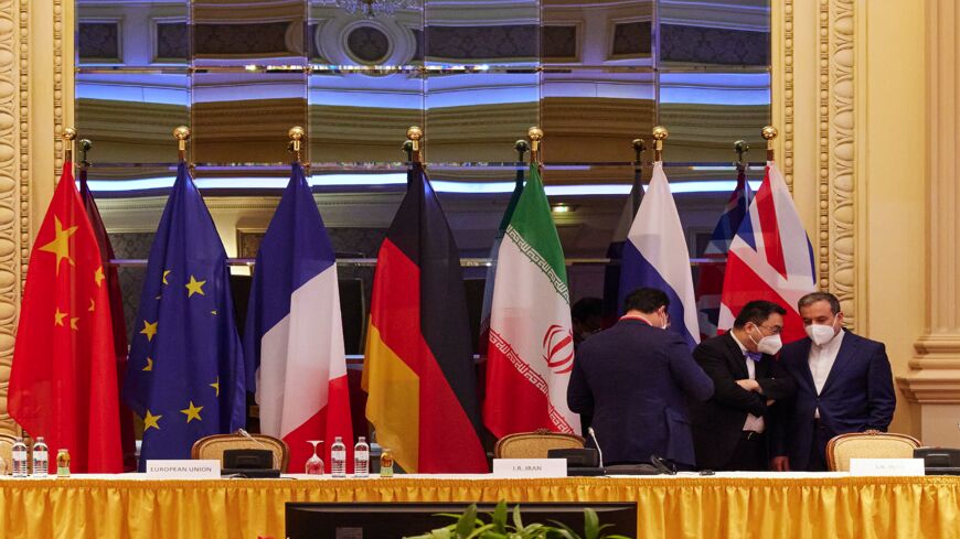 In this handout image provided by EU Delegation Vienna, Iranian Deputy Foreign Minister Abbas Araghchi (R) speaks with other participants at the JCPOA Iran nuclear talks on April 27, 2021, in Vienna, Austria. 