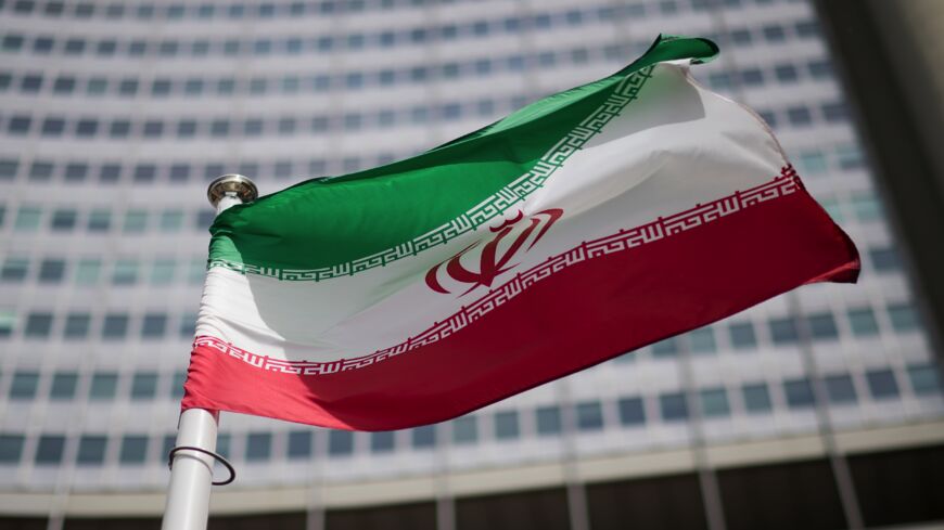 The flag of Iran is seen in front of the building of the International Atomic Energy Agency Headquarters on May 24, 2021, in Vienna, Austria. 