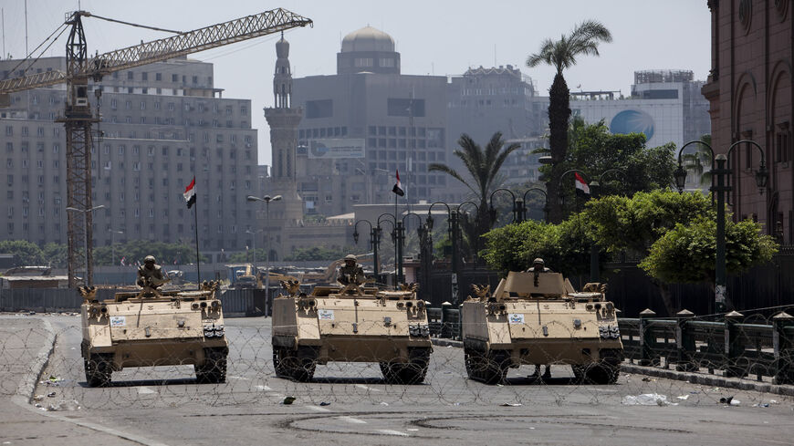 Egyptian military armored vehicles stand guard at a checkpoint on the edge of Tahrir Square near the Egyptian Museum, Cairo, Egypt, Aug. 16, 2013.